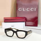 Eyeglasses with black frames and gold-tone accents with GG logo detail