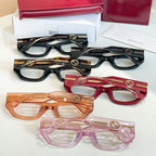Assorted eyeglasses frames in black, red, orange, and pink with GG logo details