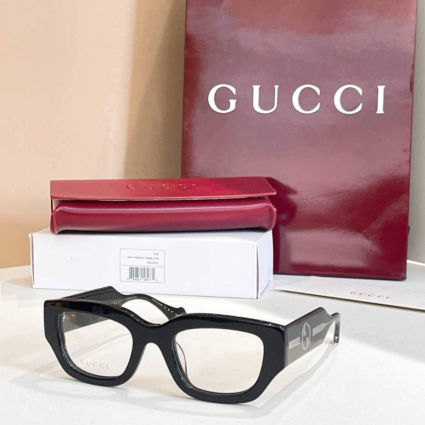Eyeglasses with black frames and gold-tone side GG logo detail