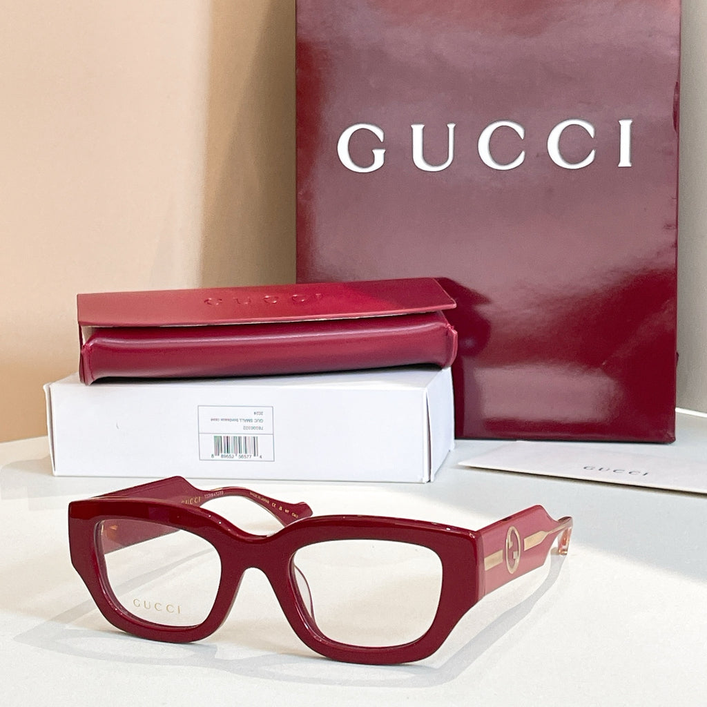 Eyeglasses with dark red frames and gold-tone side GG logo detail