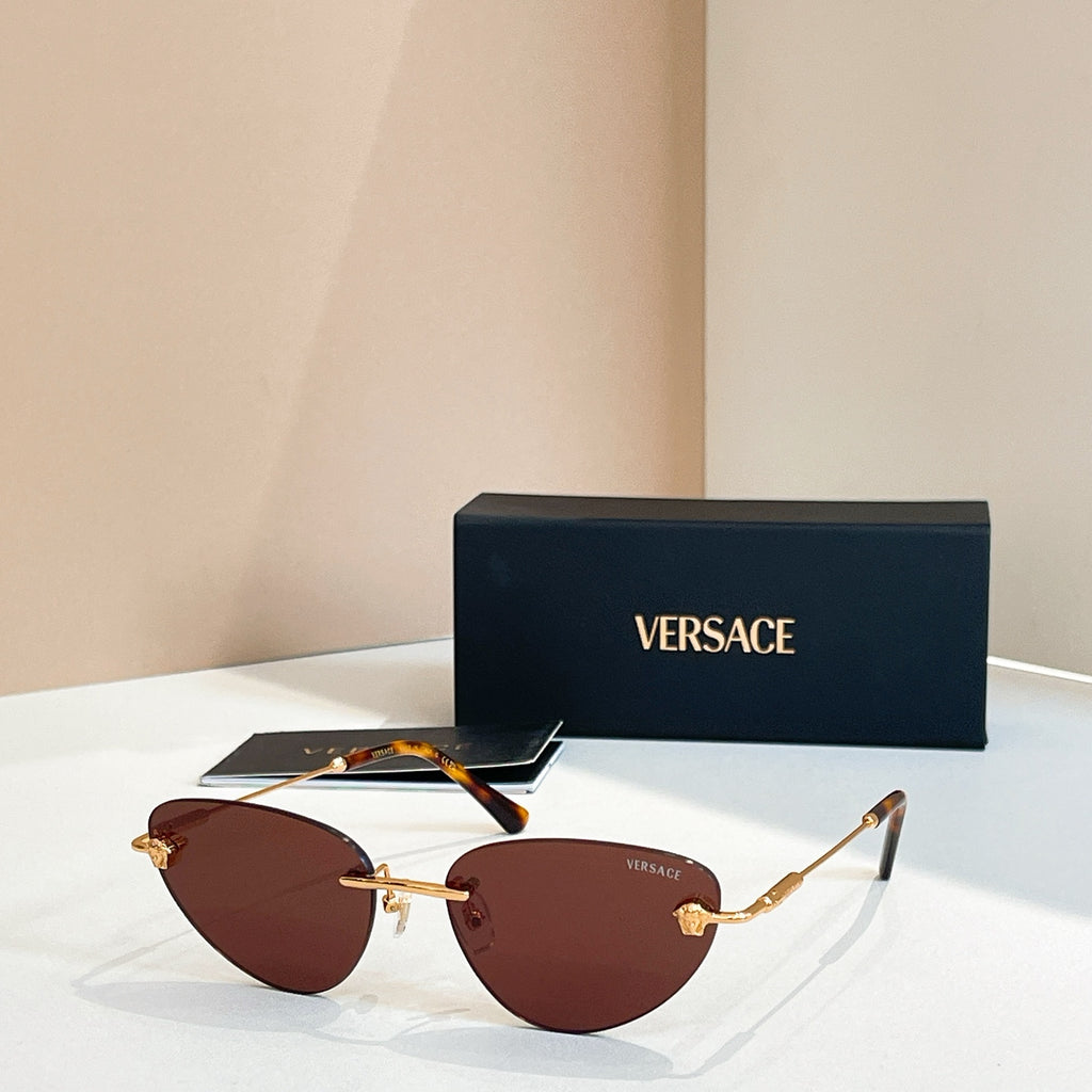 Versace sunglasses with brown tinted lenses and gold frame, round cat-eye style