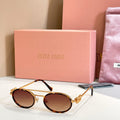 Miu Miu round sunglasses with gold frame and dark tinted lenses, side view