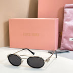 Miu Miu round sunglasses with gold frame, black lenses, black temples