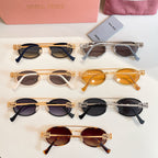 Miu Miu sunglasses assortment with gold, black, and amber frames, top view