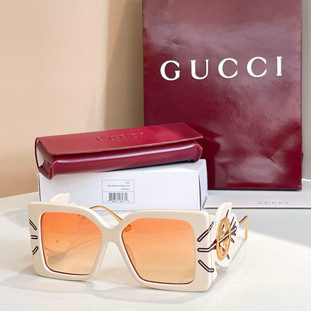 Square white sunglasses with orange lenses and gold logo on side arms