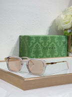 Transparent light-pink eyeglasses with tinted lenses and gold-toned arm details.