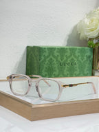 Light-pink translucent eyeglasses with clear lenses and gold-toned arm details.