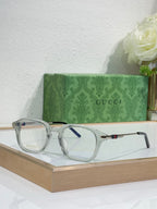 Clear smoky eyeglasses with blue-tinted lenses and gold-toned arm details.