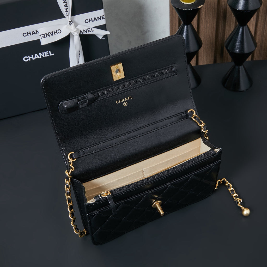 Chanel small flap bag in black leather with gold chain and top handle, open view