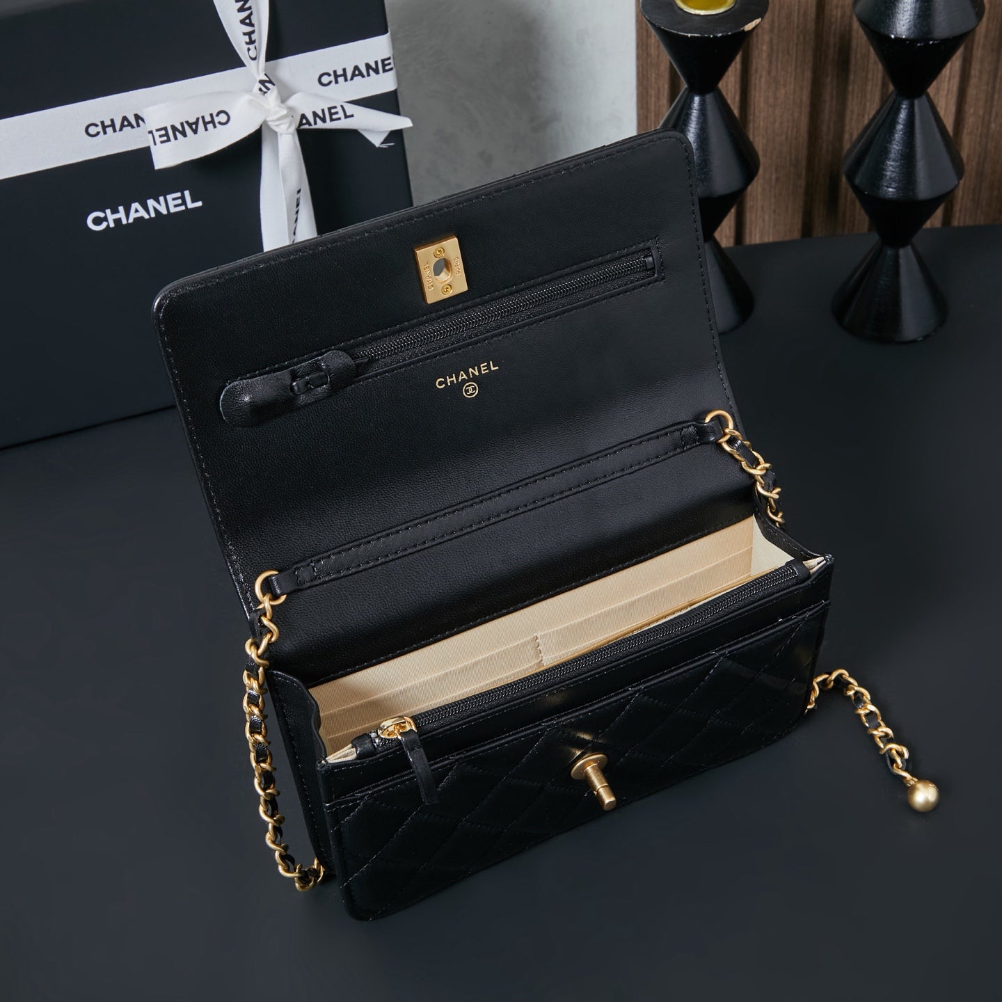 Chanel small flap bag in black leather with gold chain and top handle, open view
