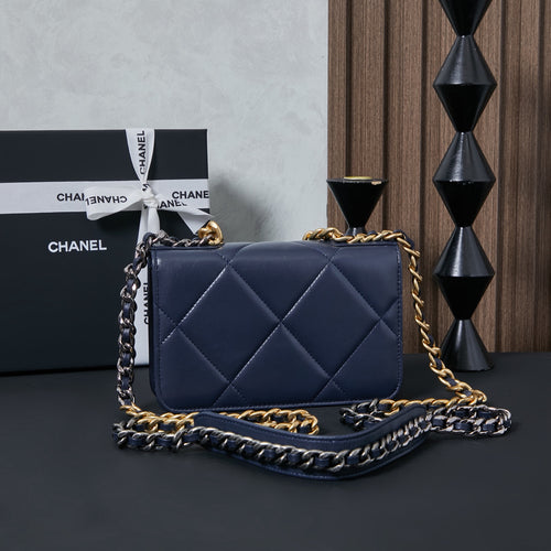 Chanel quilted flap shoulder bag, navy blue, with layered chain strap.