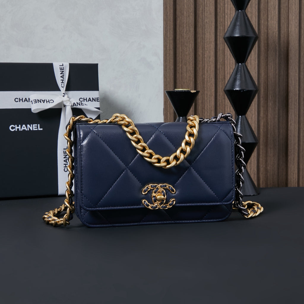 Chanel quilted shoulder bag with gold-and-black chain strap, navy blue.