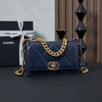 Chanel quilted shoulder bag with gold-and-black chain strap, navy blue.