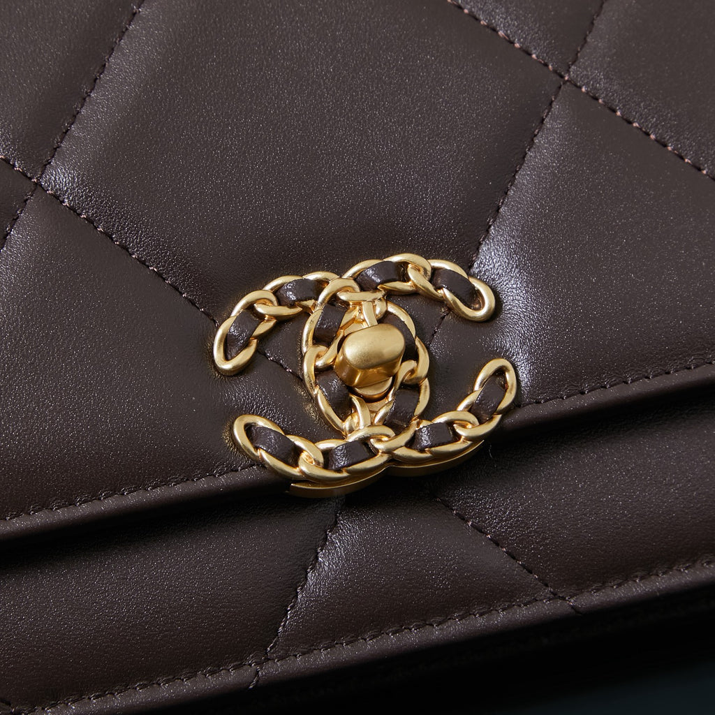 Chanel quilted bag close-up showing gold chain strap attachment