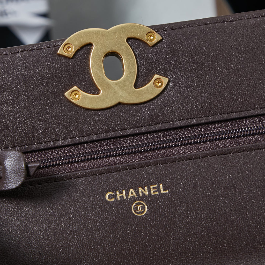Chanel logo plaque and zip close-up on quilted leather flap bag