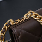 Chanel quilted bag corner close-up with gold chain strap detail