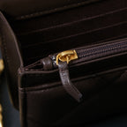 Chanel bag interior close-up with zip pocket and leather pull tab