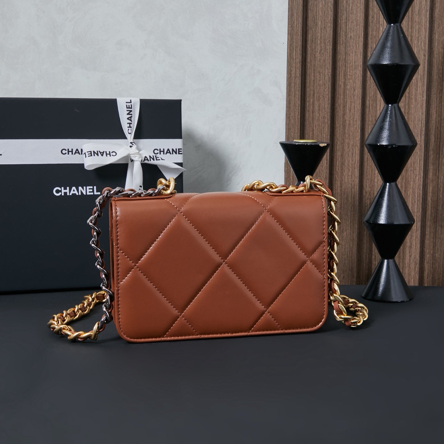 Chanel bag with tan-brown quilted diamond pattern and gold chain shoulder strap