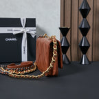 Chanel bag in tan-brown with quilted sides and long gold chain strap