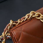 Chanel bag close-up of gold chain strap and stitched tan-brown edge