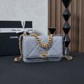 Light blue quilted flap shoulder bag with gold chain strap and logo clasp