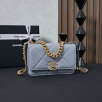 Light blue quilted flap shoulder bag with gold chain strap and logo clasp