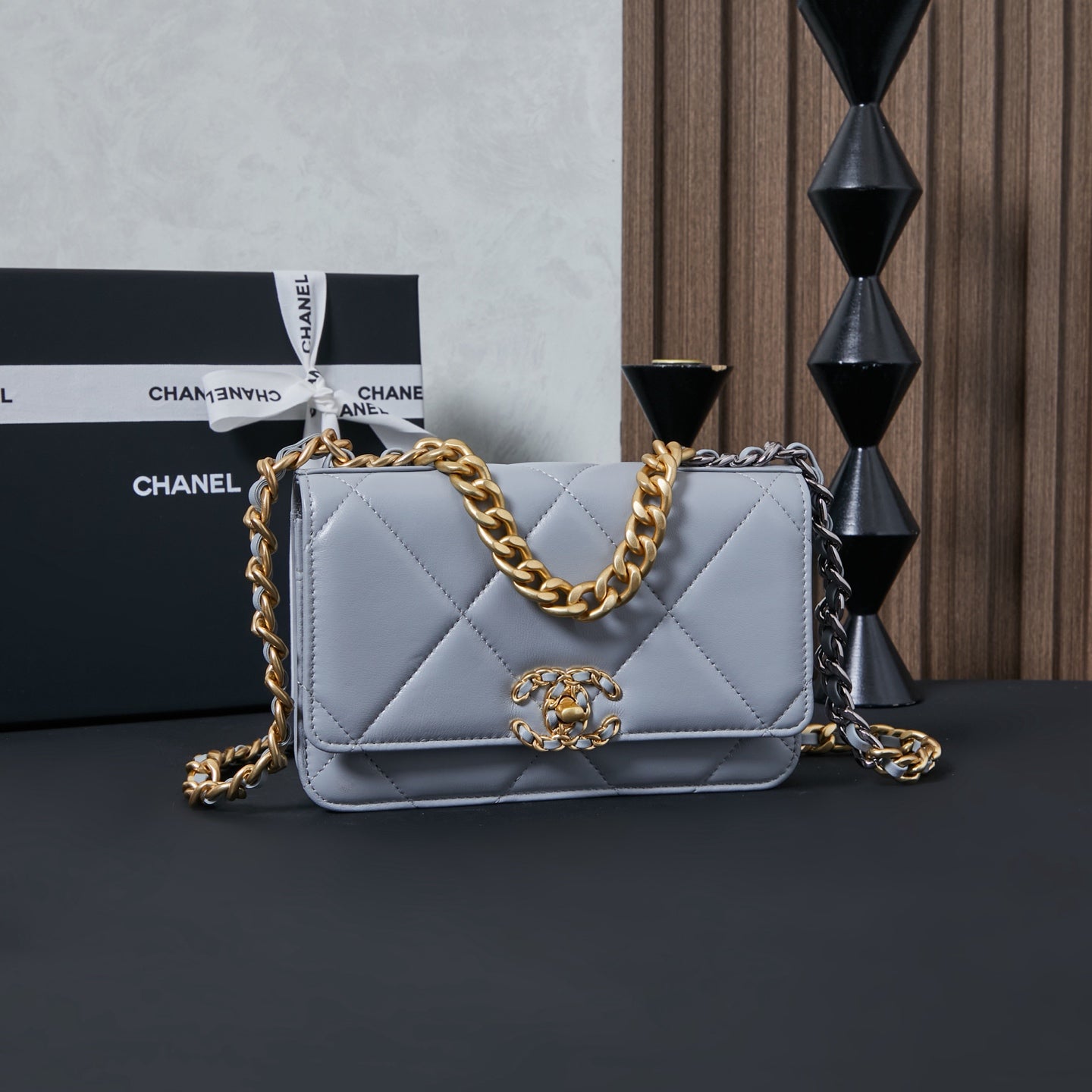 Light blue quilted flap shoulder bag with gold chain strap and logo clasp