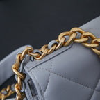 Light blue quilted shoulder bag with gold-and-silver chain strap close-up
