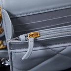 Light blue interior pocket with zipper pull and quilted lining detail