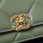 Olive green Chanel flap bag close-up of gold-tone chain and stitched quilting