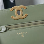 Gold-tone Chanel CC logo on olive green flap bag with zipper edge
