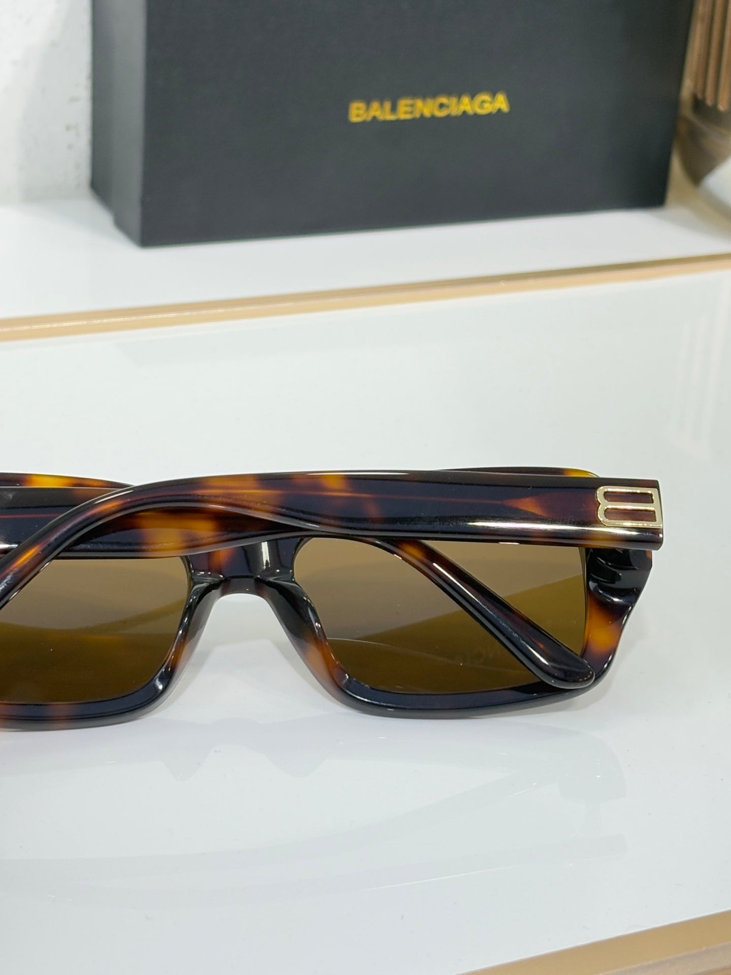 Balenciaga glasses, tortoiseshell temple side with gold double-B logo detail