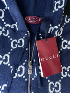 Navy GG-pattern hoodie with front zip and white Gucci hang tag