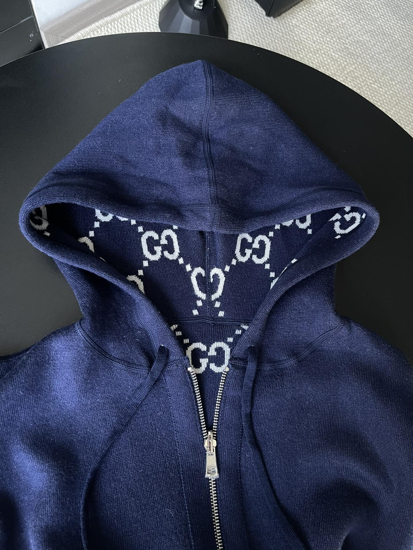 Navy zip hoodie hood with drawstring and small GG monogram pattern trim