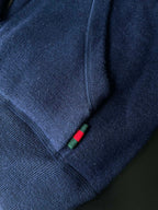 Navy hoodie cuff with drawstring stopper featuring multicolor stripes