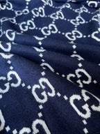 Navy knit hoodie with repeating GG monogram pattern detail