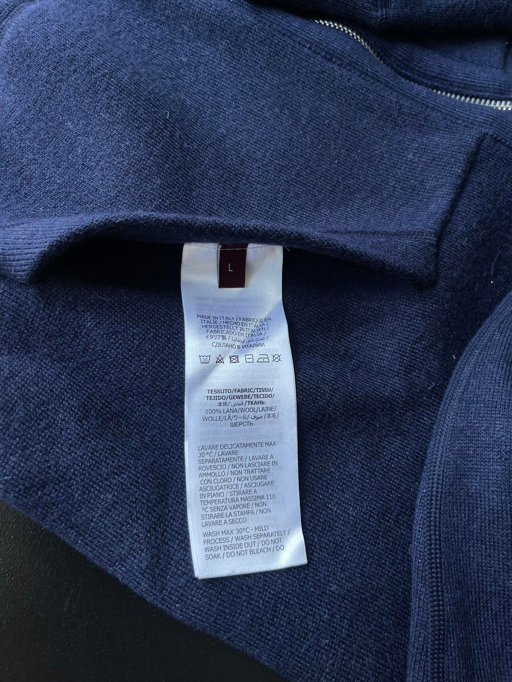 Navy zip hoodie with interior size tag on neckline seam