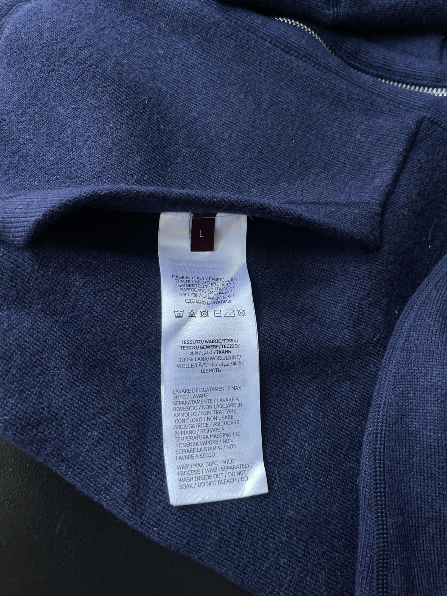 Navy zip hoodie with interior size tag on neckline seam
