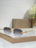 Bvlgari sunglasses with dark gray gradient lenses and gold-tone metal frames