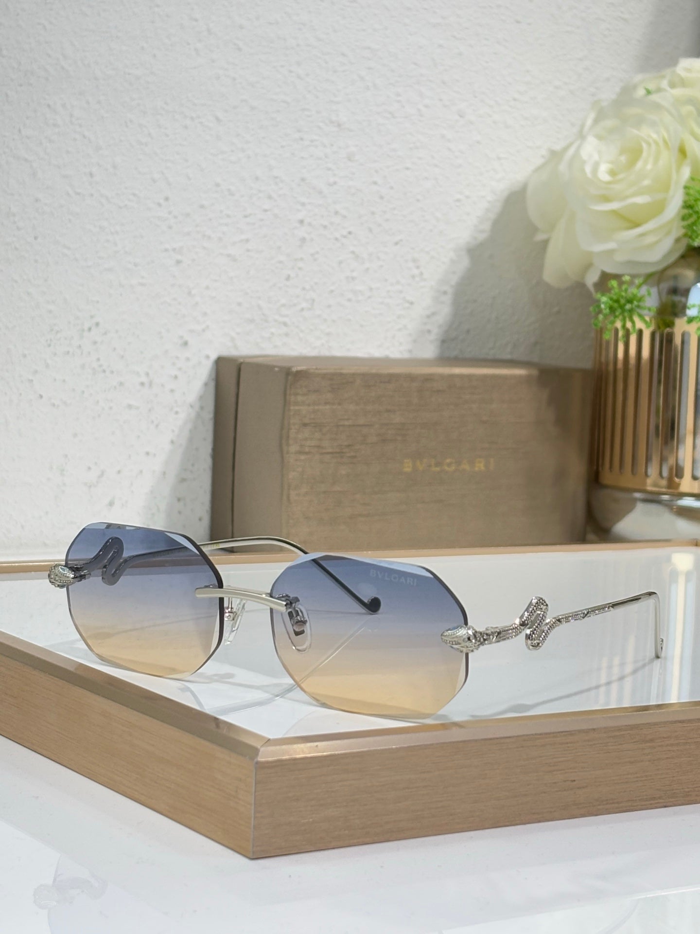 Bvlgari sunglasses with blue-tinted lenses and silver-tone metal frames