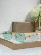 Bvlgari sunglasses with teal gradient lenses and gold-tone metal frames