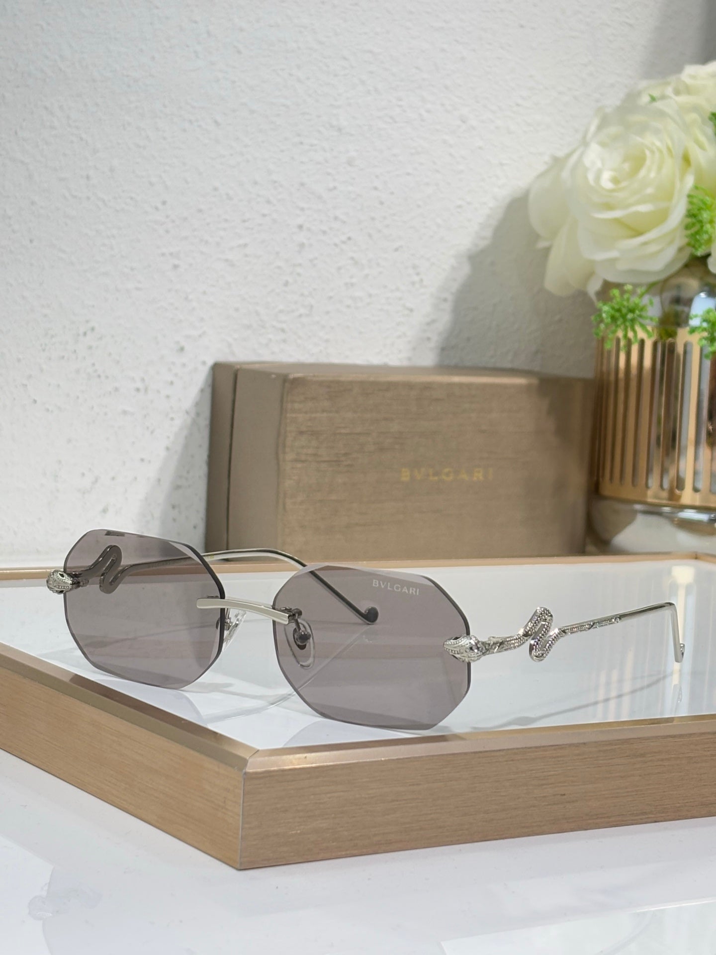 Bvlgari sunglasses with smoky gray lenses and silver-tone metal frames