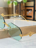 Bvlgari sunglasses side view with teal gradient lenses and gold-tone metal frames