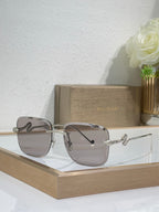 Bvlgari round sunglasses with silvertone frame and brown gradient lenses