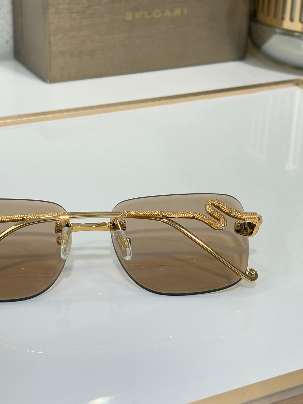 Bvlgari round sunglasses with gold frame and brown gradient lenses, side view