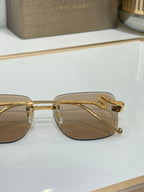 Bvlgari round sunglasses with gold frame and brown gradient lenses, side view