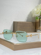 Bvlgari round sunglasses with gold frame and light teal gradient lenses