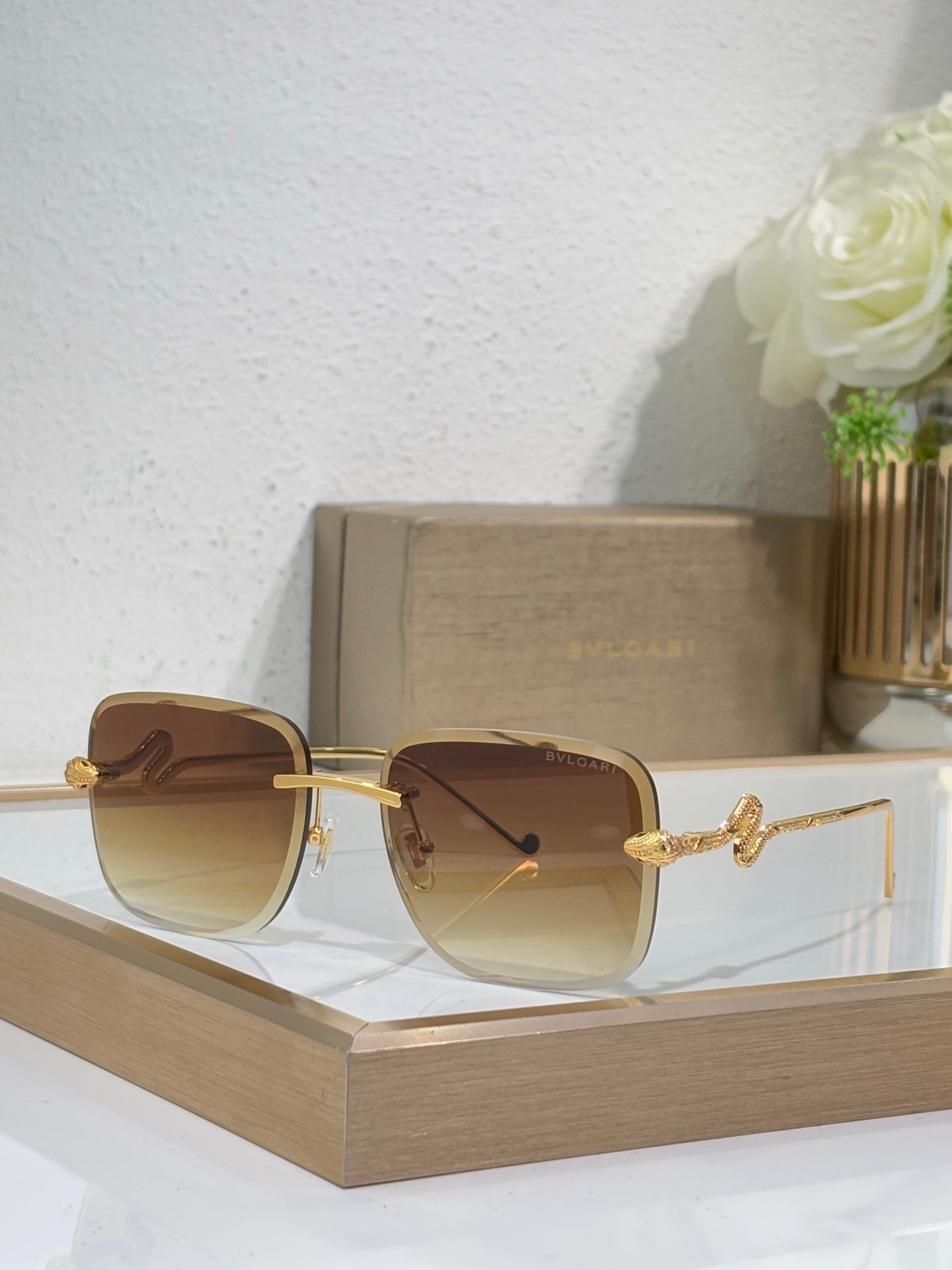 Bvlgari round sunglasses with gold frame and amber gradient lenses