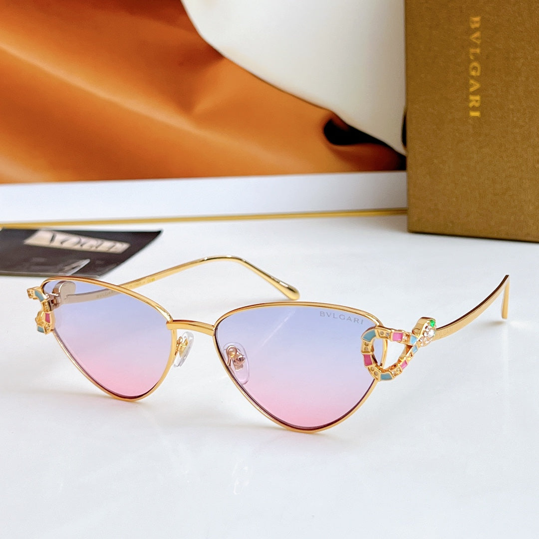 Gold cat-eye glasses with pastel purple lenses and multicolor jeweled frame detail