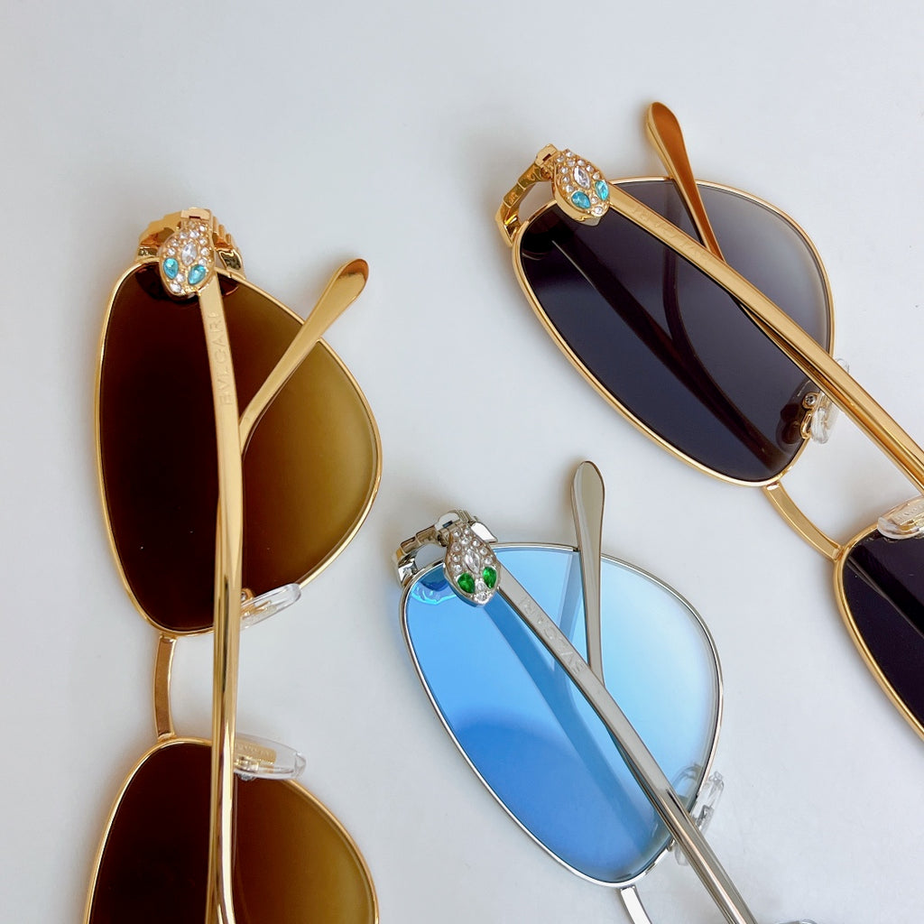 Jeweled glasses set with blue and dark lenses, gold and silver frames